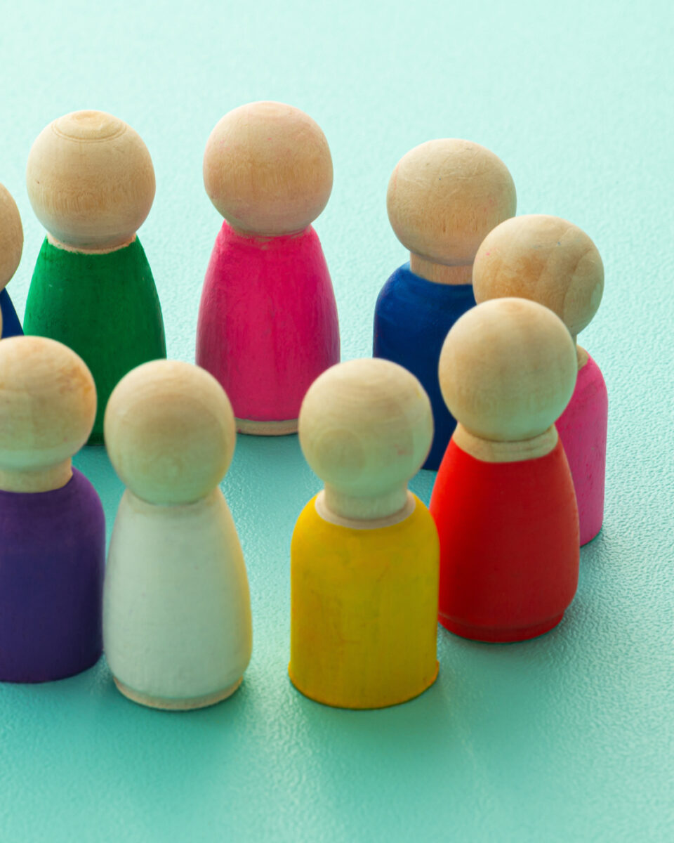 Concept of teamwork, inclusion, and teamwork, expressed with colored wooden pieces.